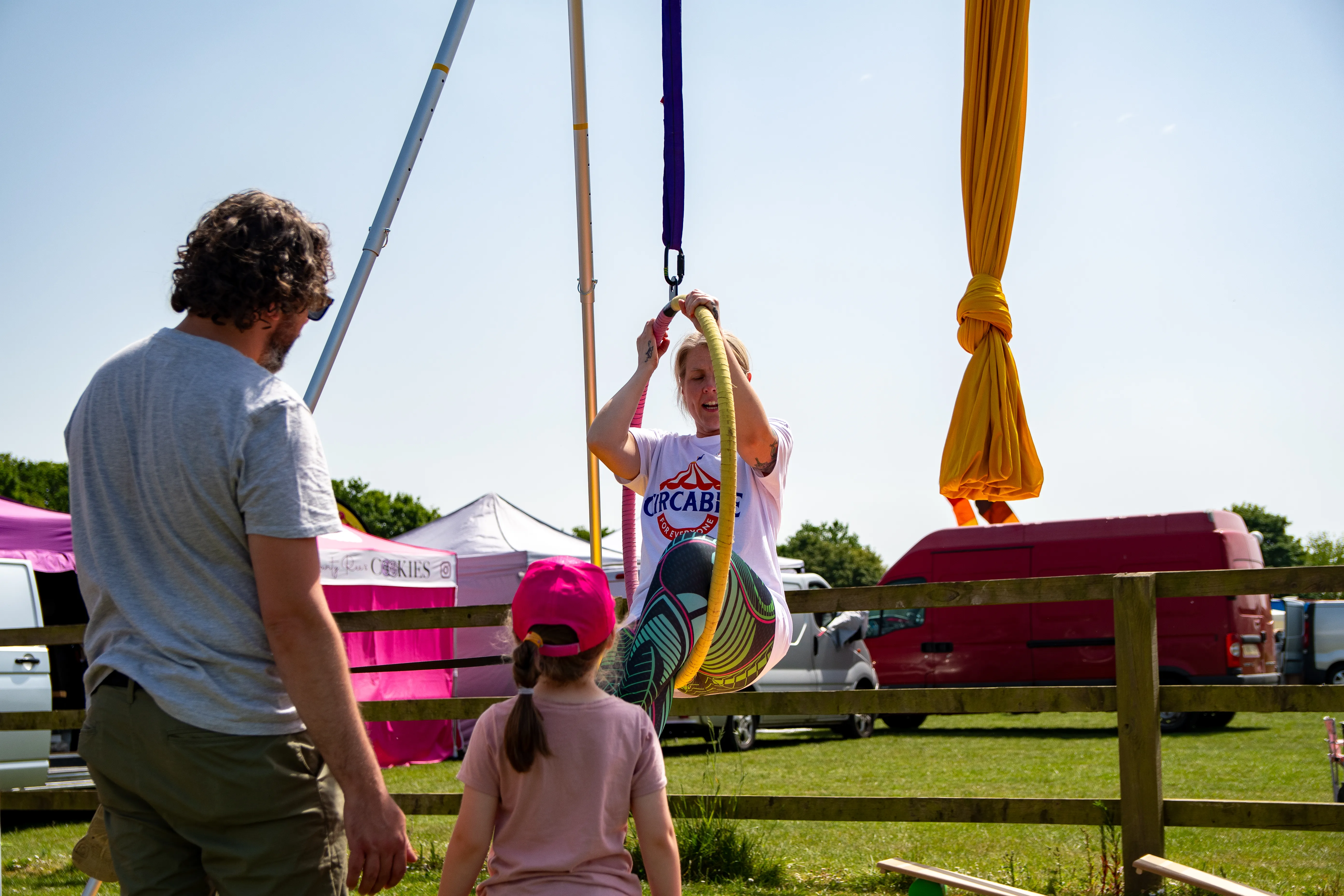 Children playing on hanging aerial silks in the activity area.