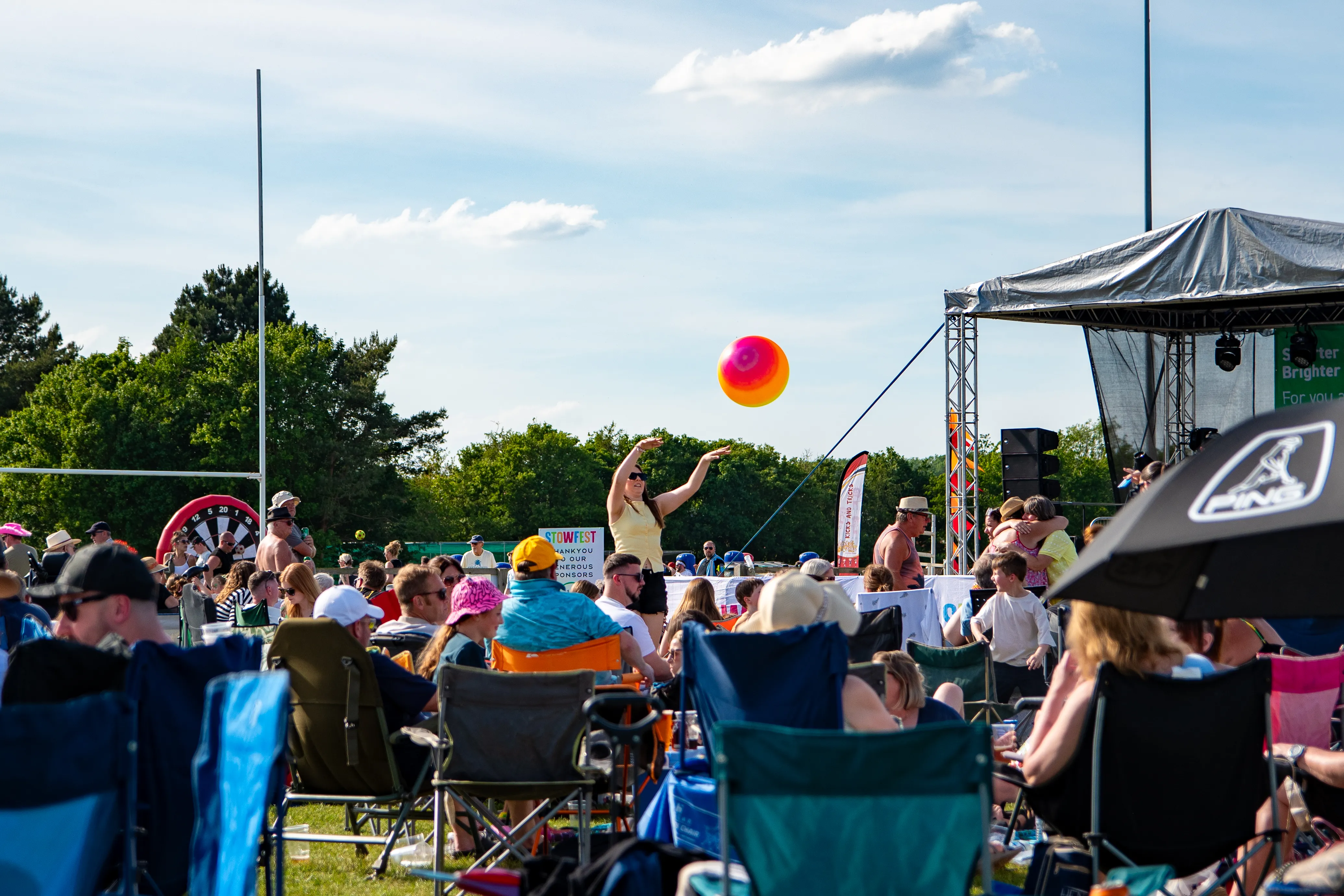 A beach ball bouncing over the seated crowd in front of the stage.
