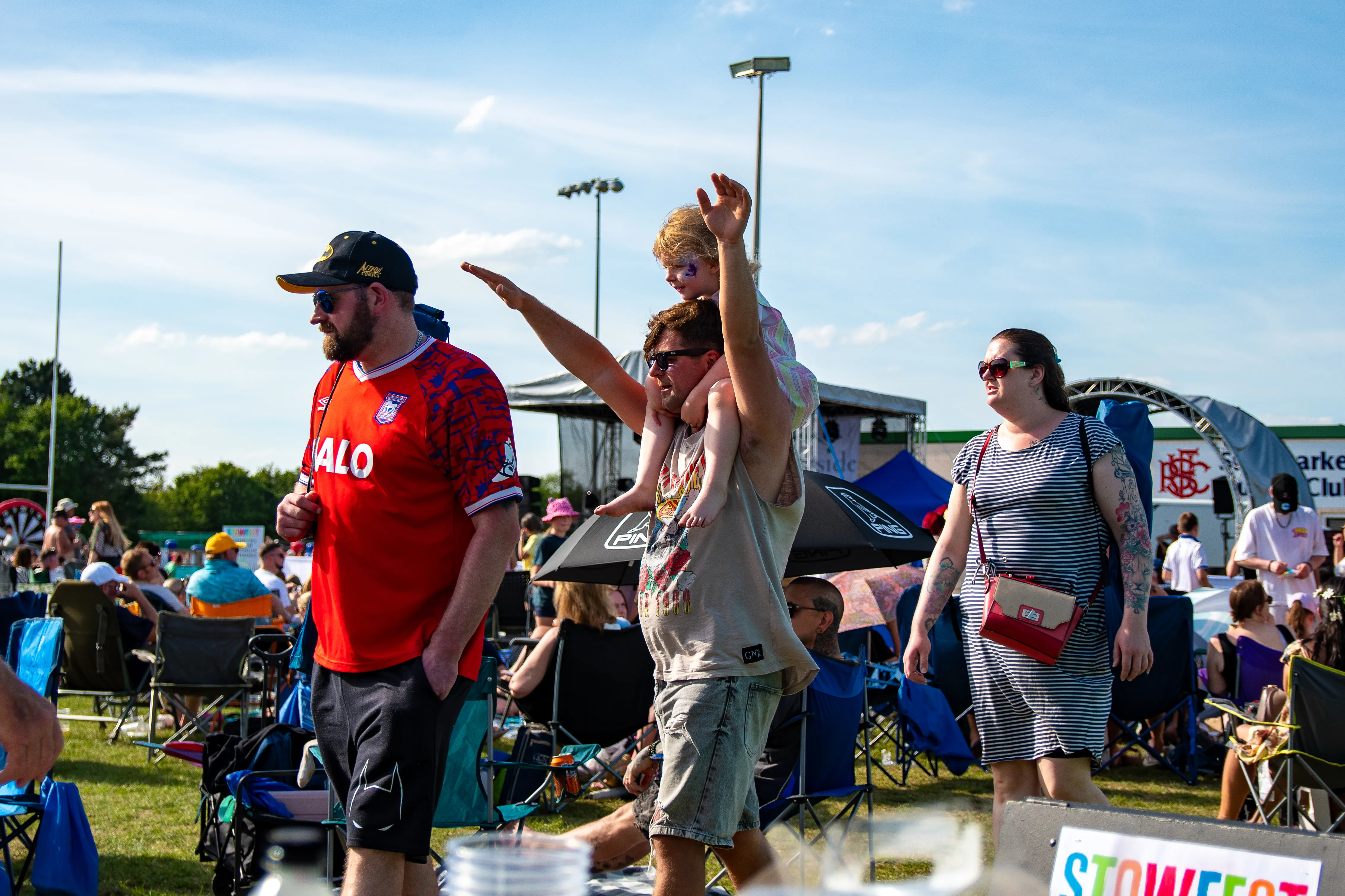 A row of men cheering and pointing during a set.