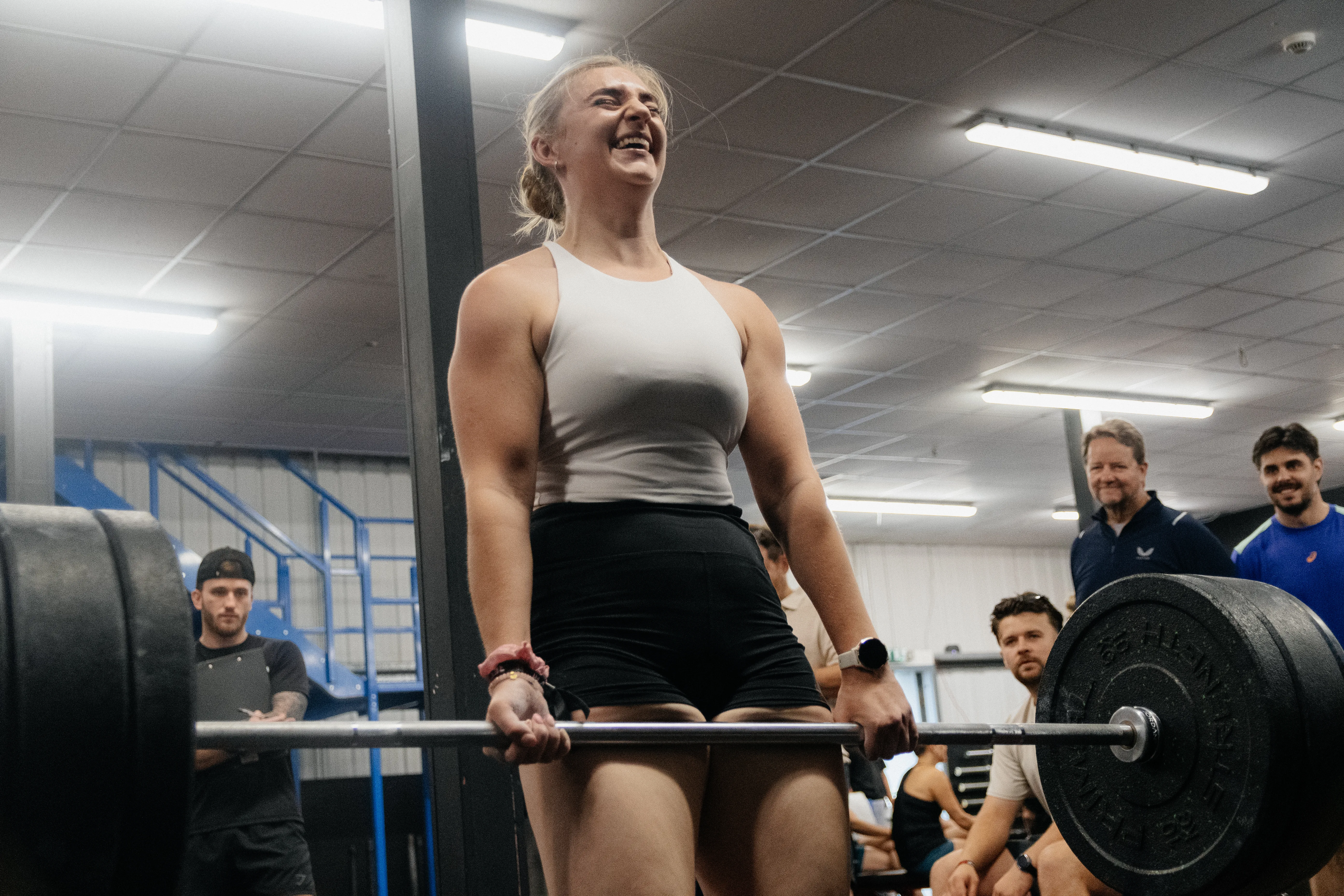 A gym competitor mid-deadlift, face showing every kilo of effort.