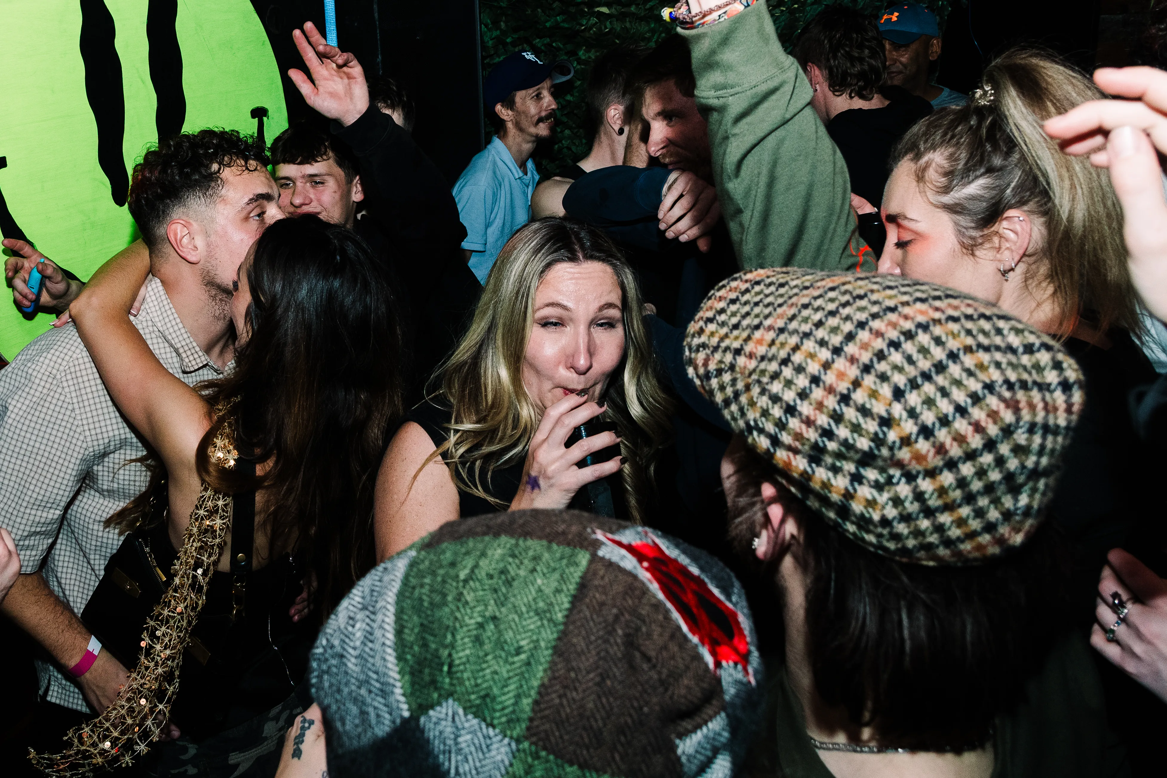 The dancefloor in full swing beneath the green Funktion logo, faces caught mid-laugh.