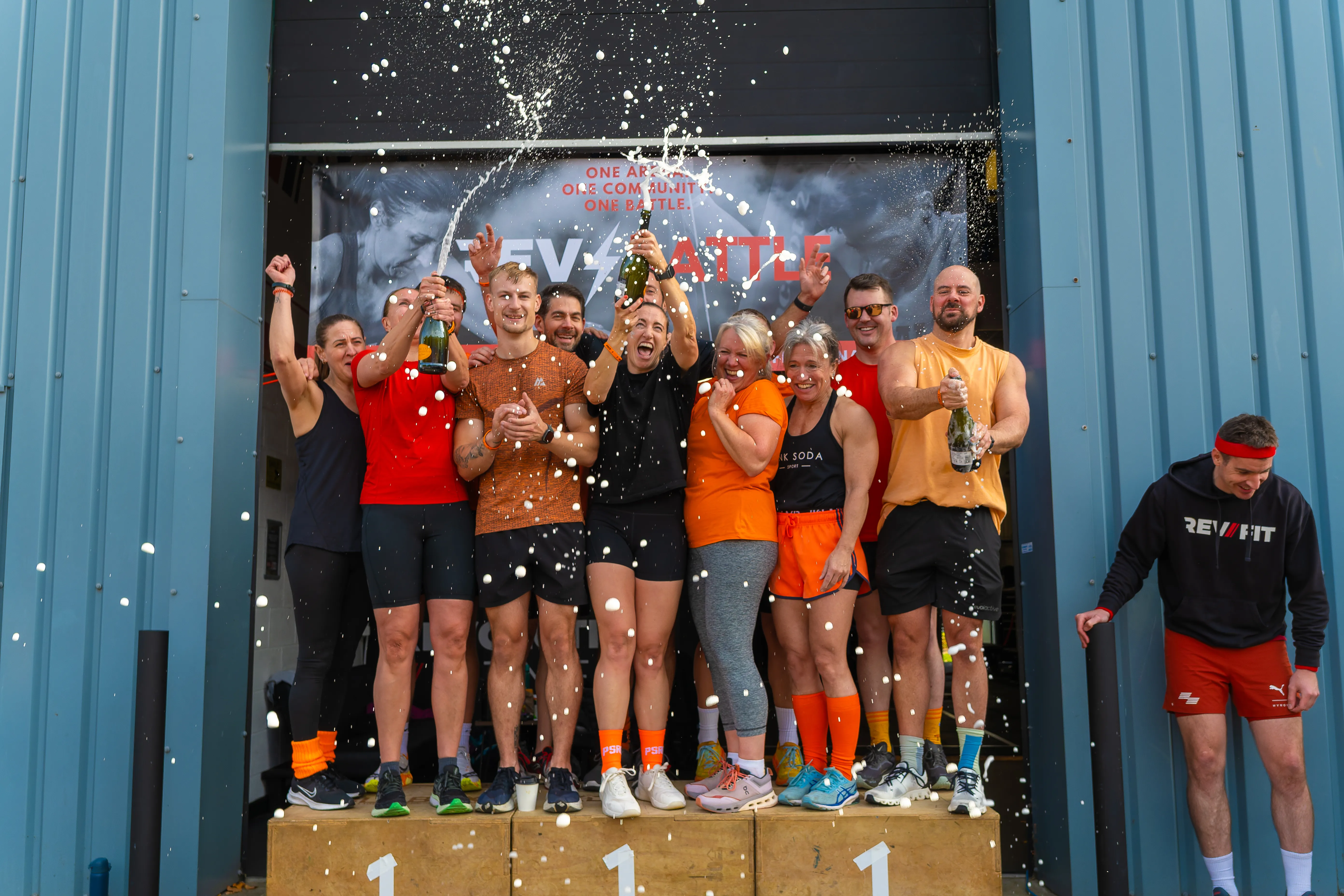 Champagne spraying over the podium as the winners celebrate.
