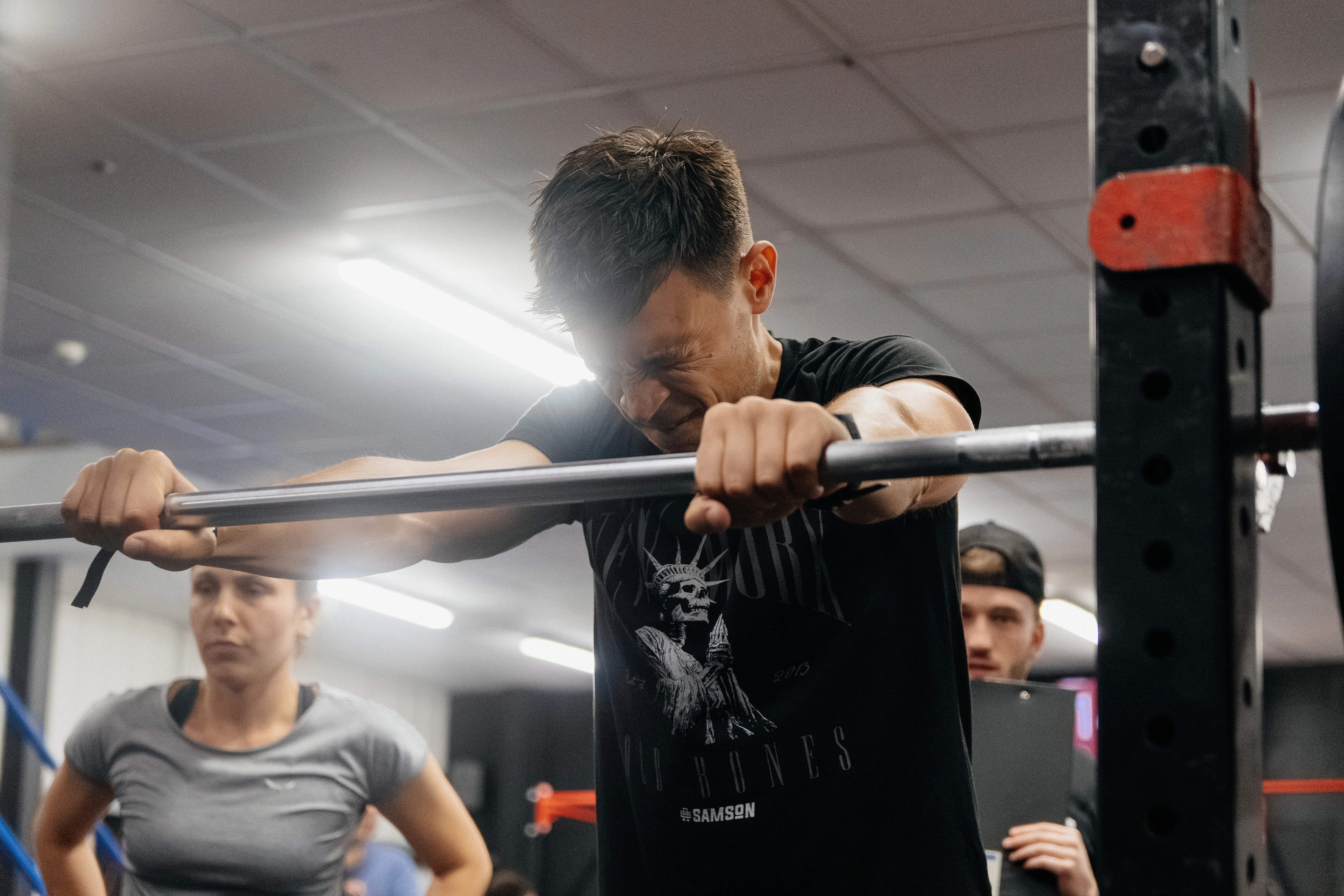 A competitor head down over the bar, gathering himself before a lift.