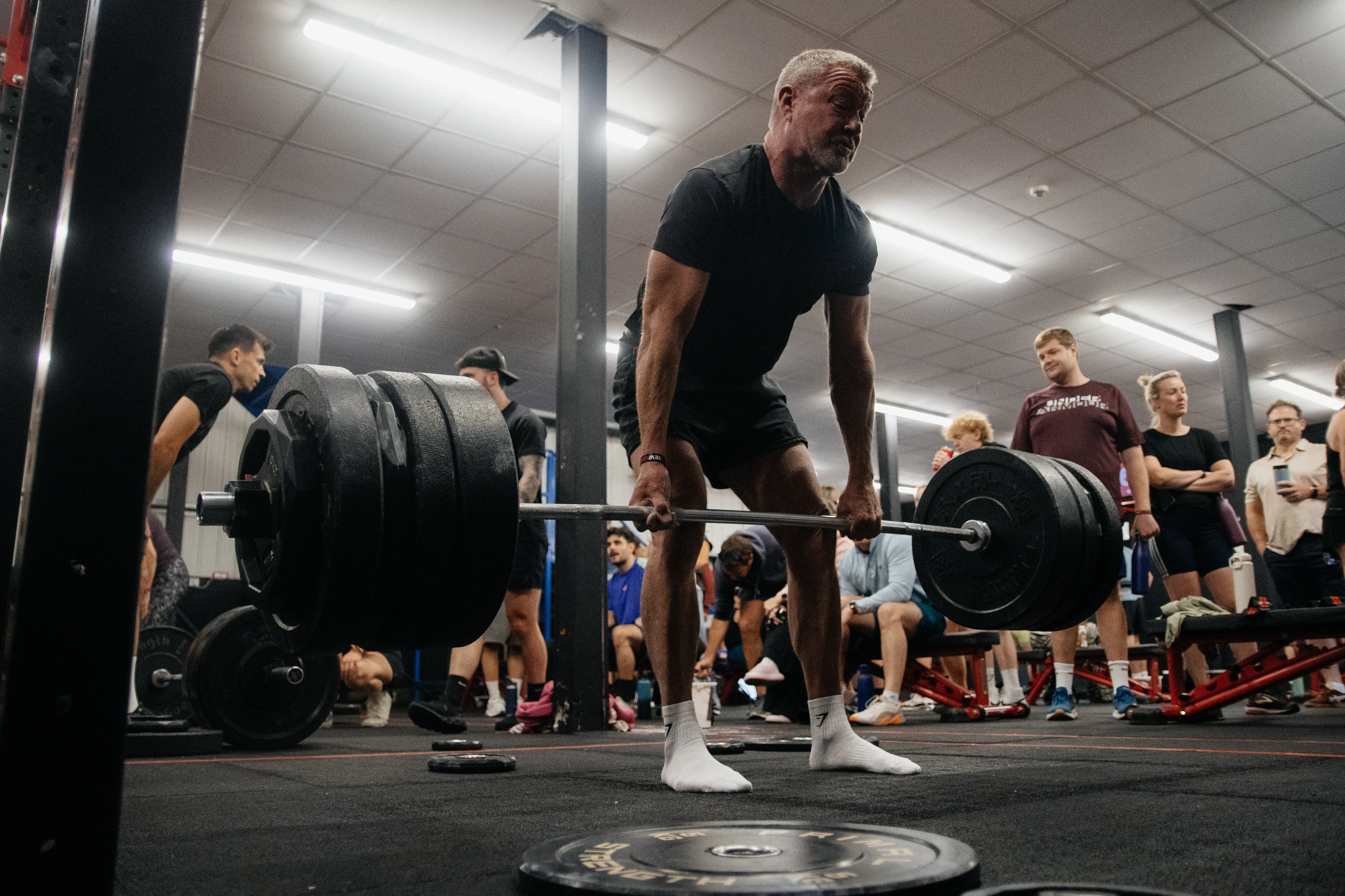 A competitor setting his grip for a heavy deadlift.