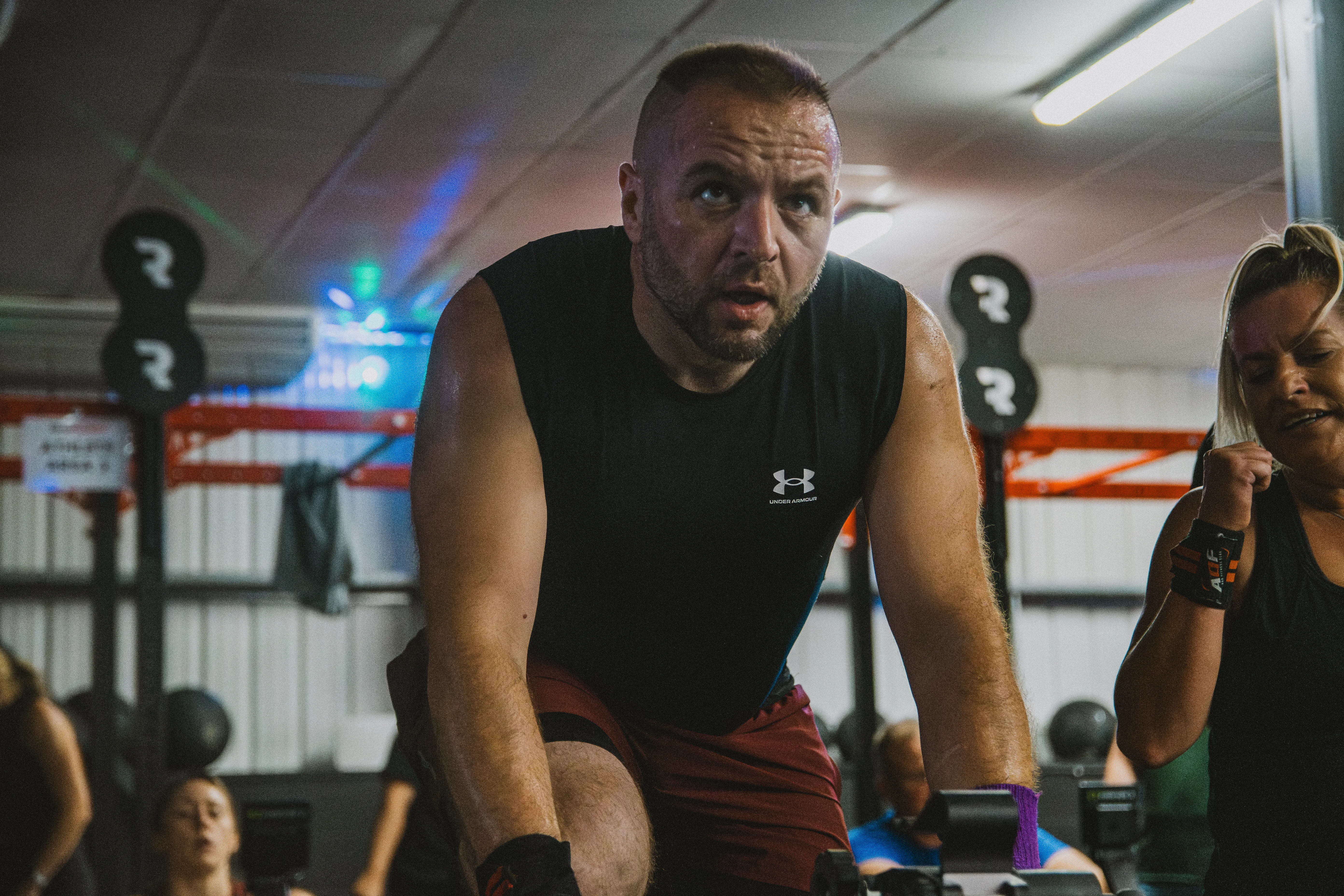 A competitor locked in on the assault bike, eyes fixed ahead.