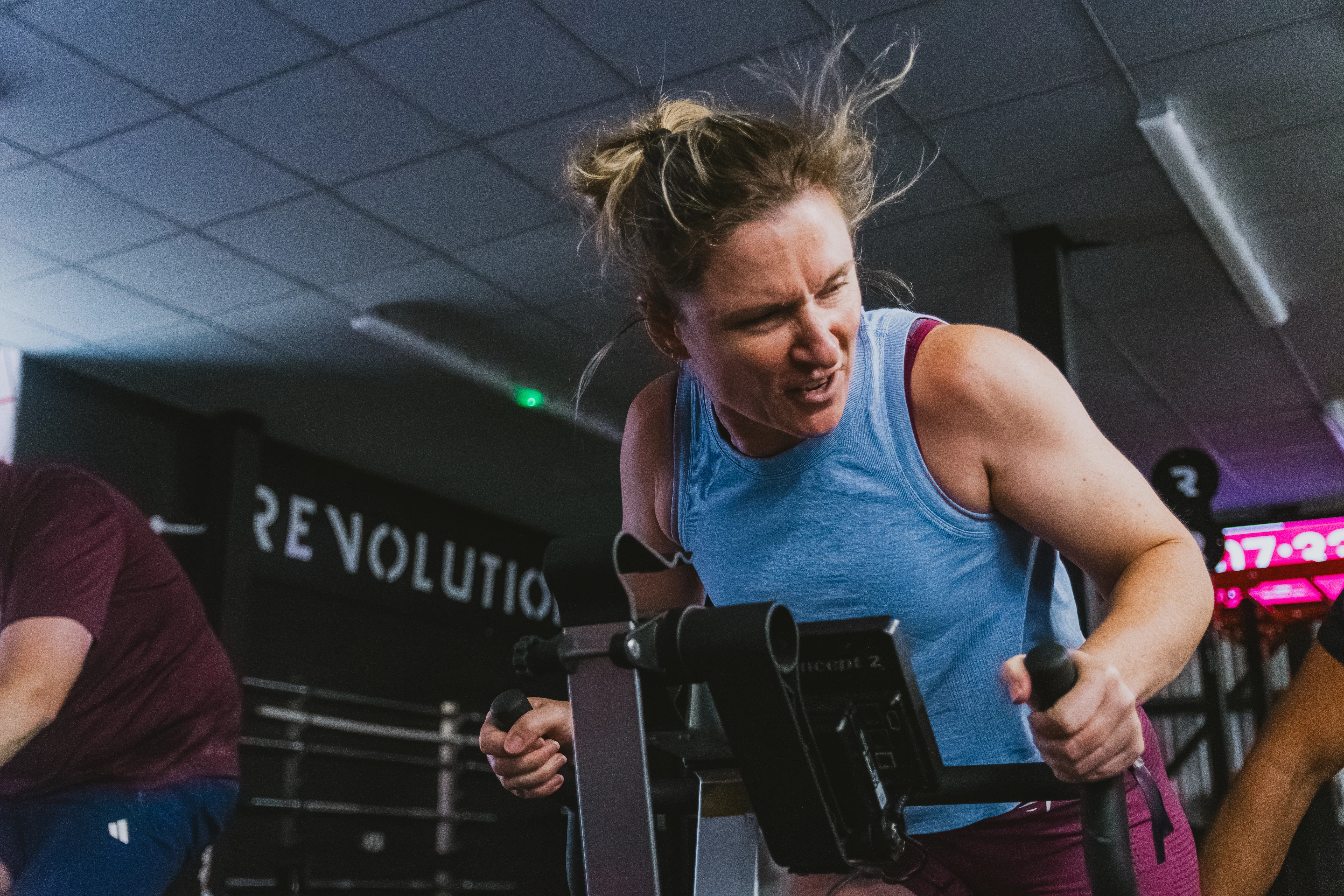 A competitor mid-stroke, hair flying, deep into the workout.