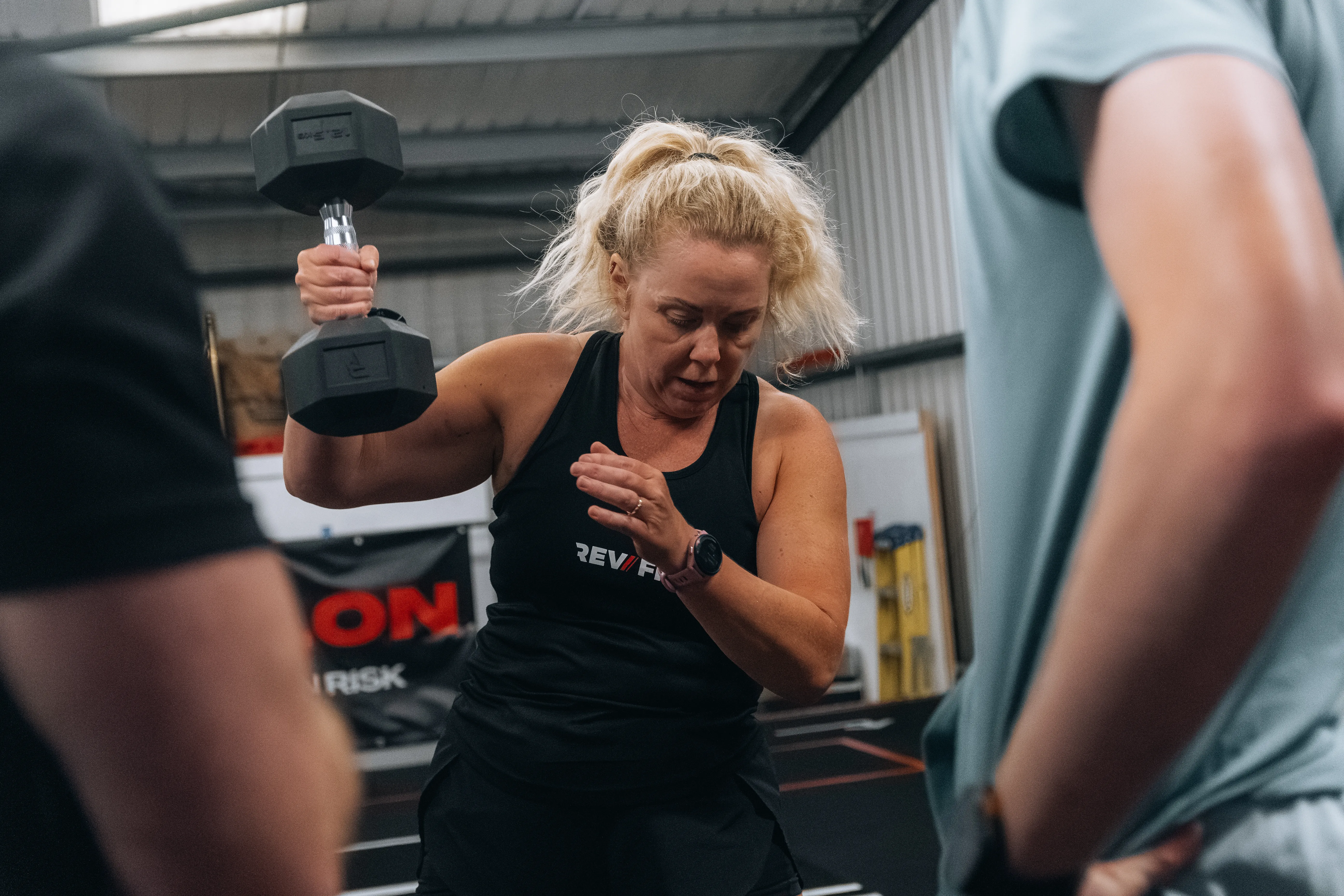 A competitor gritting through a dumbbell carry.